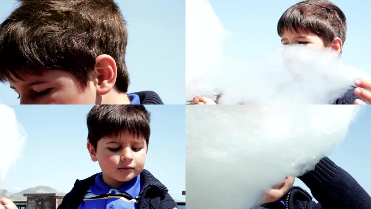 可爱的小男孩吃白色甜棉花糖。