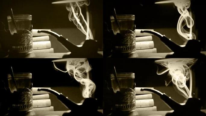 玻璃烟斗中的烟斗烟雾和茶的旧电影效果镜头