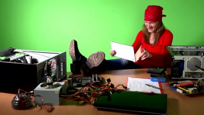 粗心的工程师女人，腿在桌子上玩平板电脑