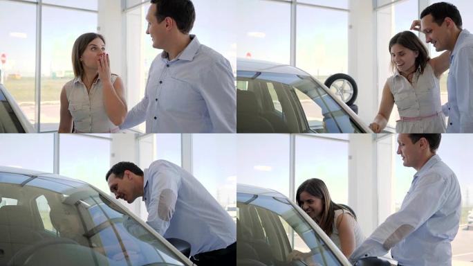 汽车销售中心，男人在展示厅用新车给女孩惊喜，女朋友礼物给女孩惊喜新车，男人站在女人后面