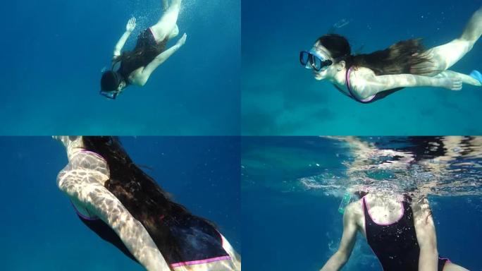 女孩带着水下面具在海里潜水