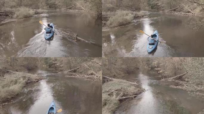 男子在森林河上划独木舟