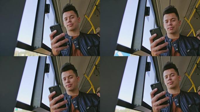 一个年轻人在公共汽车上使用智能手机