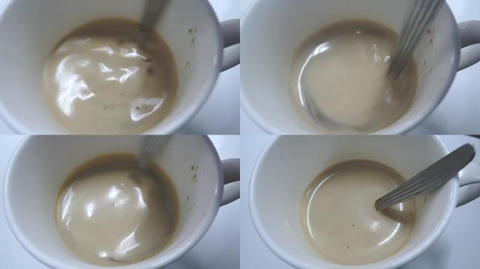 4k在白咖啡杯中搅拌咖啡