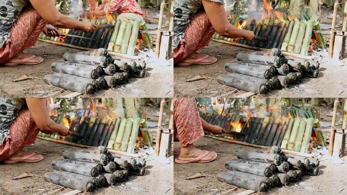 女人把竹饼放在火上做饭