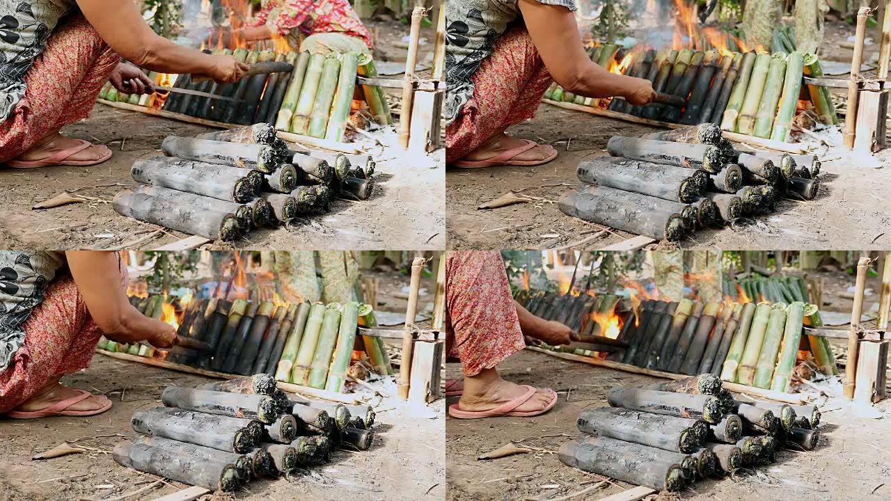 女人把竹饼放在火上做饭
