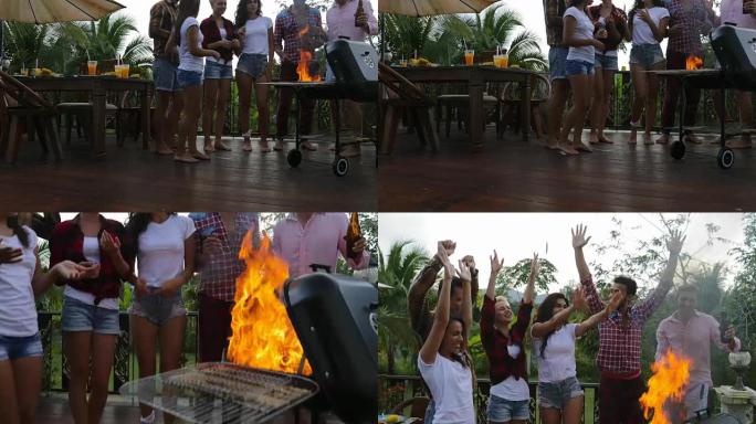 年轻人开朗的烹饪烧烤快乐的朋友团体举手聚会在夏季露台上举行聚会
