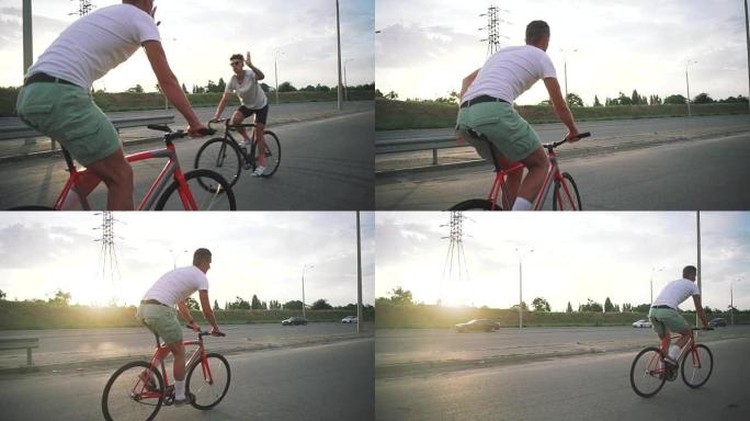 一群骑自行车的人在路上骑固定齿轮的自行车，稳步射击，慢动作，给予击掌