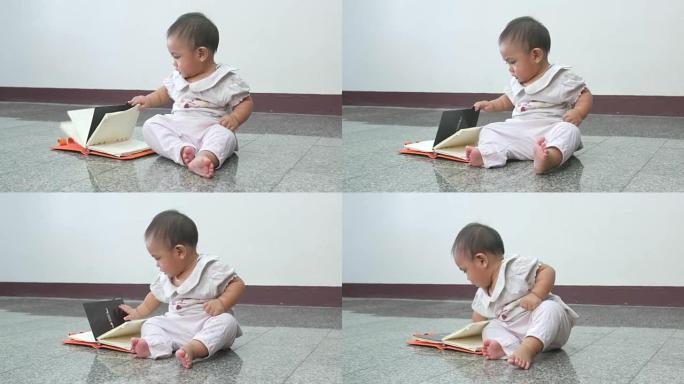 婴儿尝试打开书本