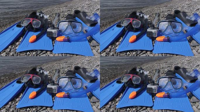 野生卵石滩上的两台浮潜装置和水下数码相机