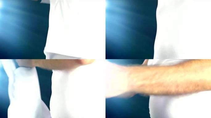 足球运动员脱下他的白色t恤，换一件蓝色的，慢动作