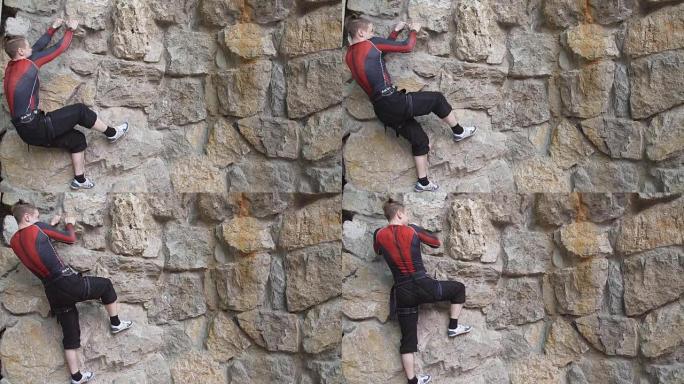 拥有特殊装备的年轻运动员爬墙。在攀岩比赛中，盖伊在岩壁上攀爬。慢动作
