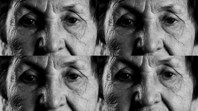 Blac和white拍摄了一位老妇的皱纹脸的特写镜头