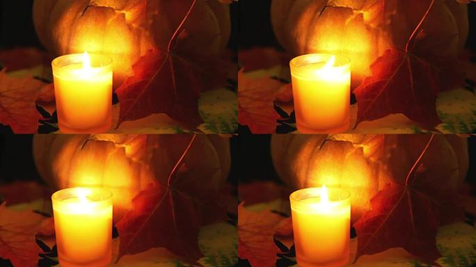 蜡烛在南瓜前燃烧。万圣节