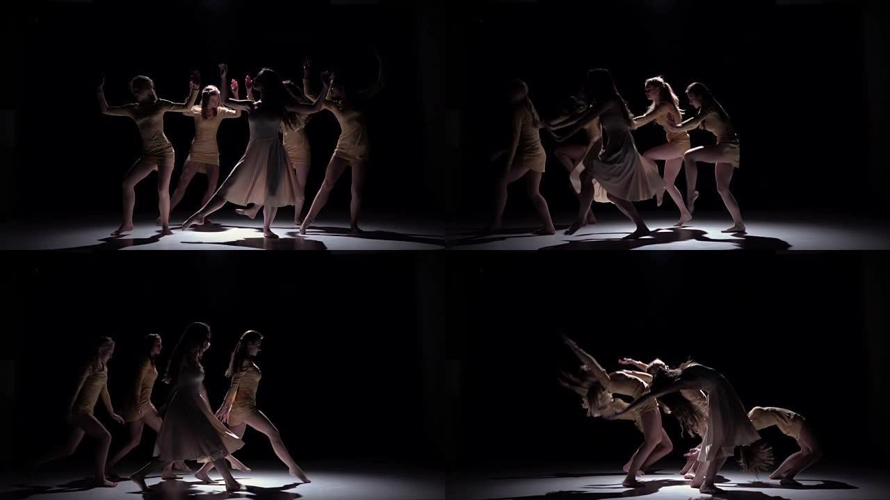 五位穿着白色衣服的舞者在黑色，阴影，慢动作上的优美当代舞蹈