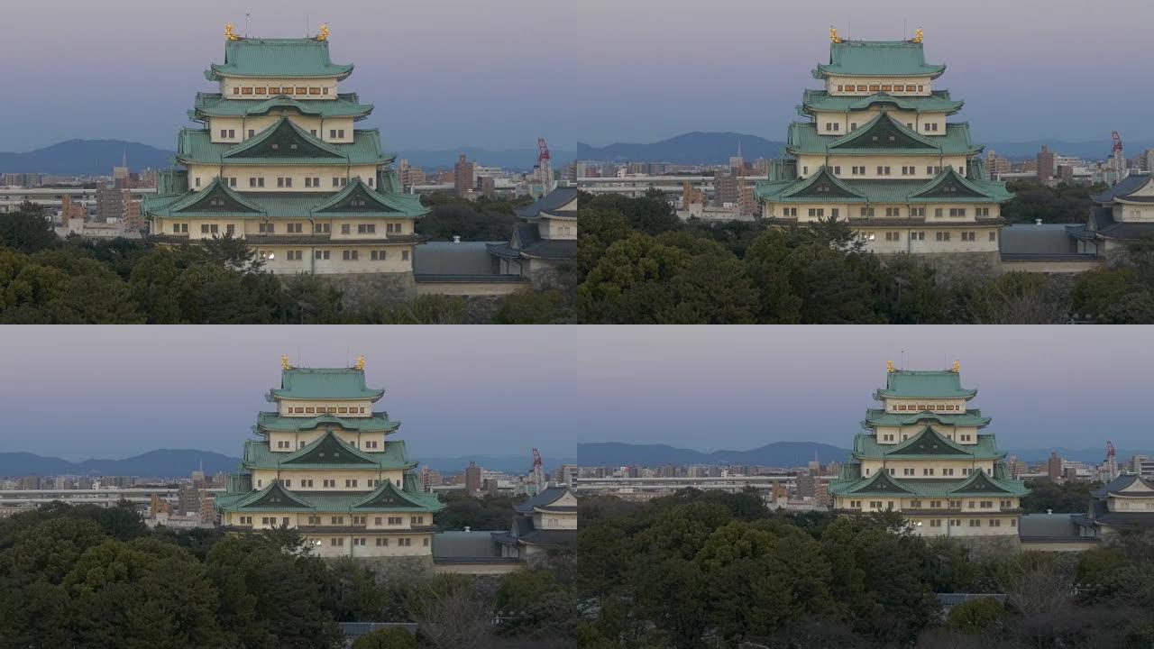 缩小从Nagoyajo城堡到黄昏天空中的城市天际线的镜头。