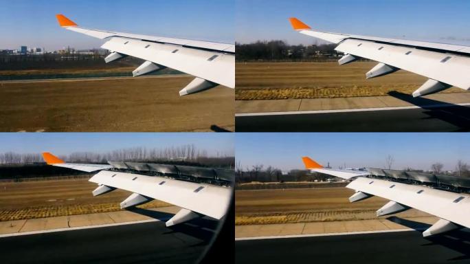 飞机降落在机场，从内部看到机翼