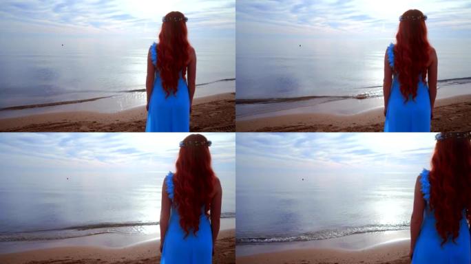 红发女人看着大海。后视女人海滩。海边的女人