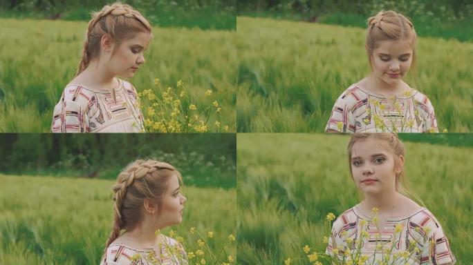 可爱的年轻女孩拿着一束油菜花，在田野里摆姿势