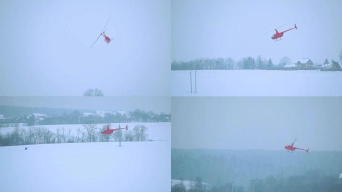 红色直升机在冬季通过电力线起飞。