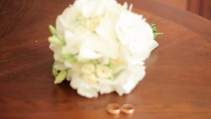 婚礼花束和结婚戒指放在桌子上