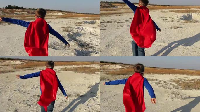 超级英雄男孩穿过山脉，试图飞翔