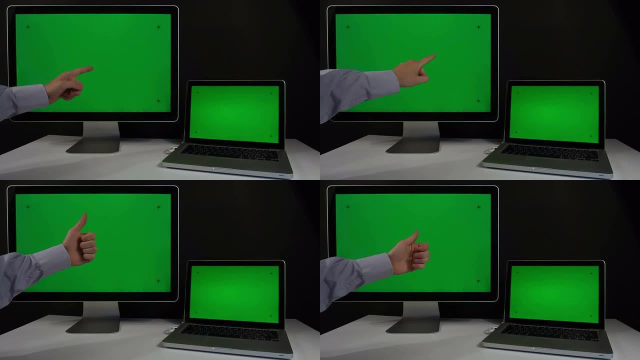 笔记本电脑和带有绿色屏幕的显示器