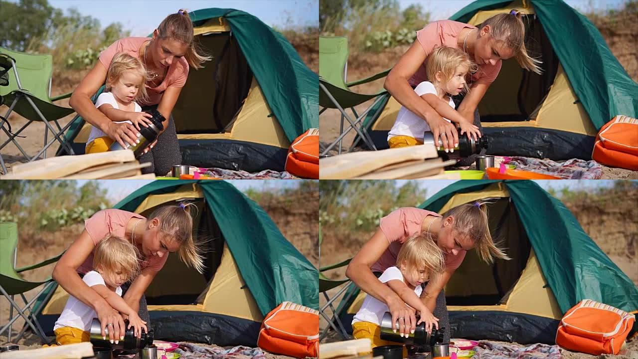妈妈和女儿想在露营旅行中用热茶取暖