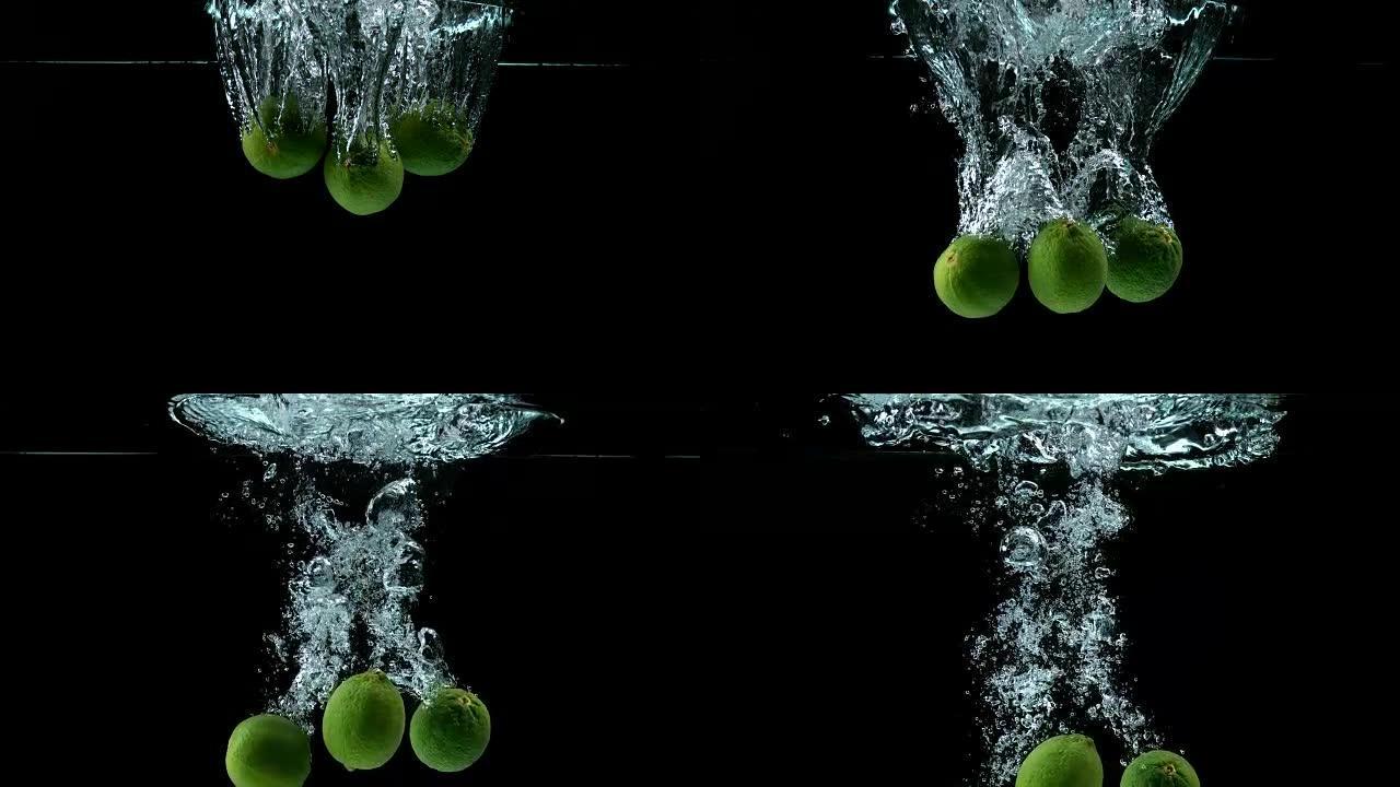 绿色柠檬，柑橘，黑色背景下落水的水果，慢动作4K