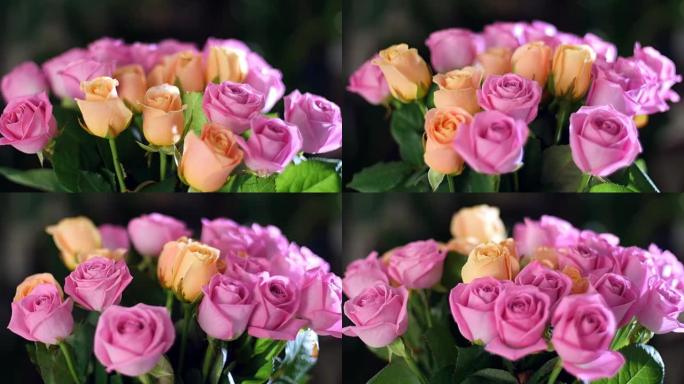 特写镜头，花束在光线中，旋转，花卉组成由粉红色和橙色玫瑰水色组成。背景中有很多绿色植物。神圣之美