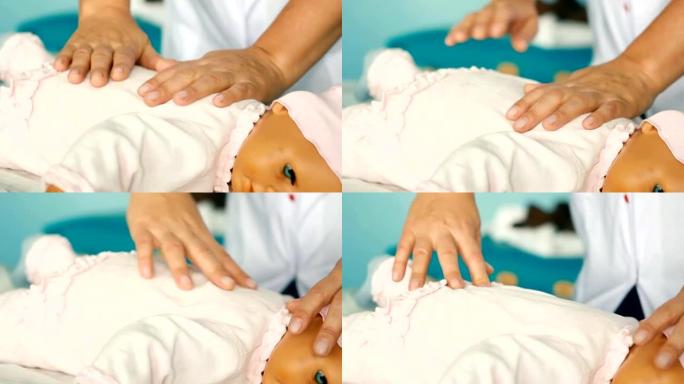 一只手压迫婴儿训练娃娃进行心肺复苏术的妇女