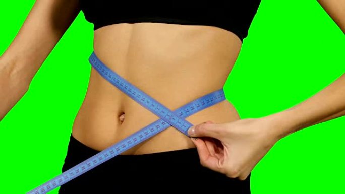 健身女人测量身体，运动服。详细信息，绿色屏幕