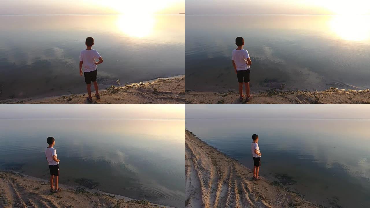 一名小学生站在悬崖上看着黑海的空中镜头