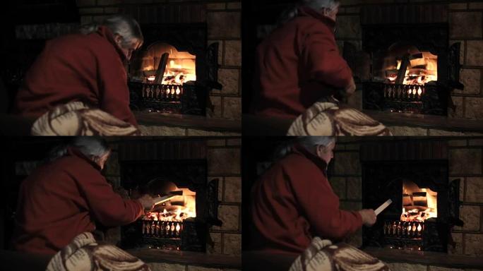 老人把柴火扔进壁炉