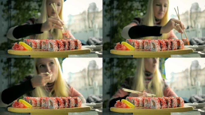 在日本餐馆用筷子吃寿司的女孩
