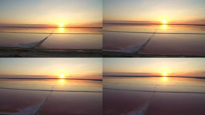 鸟瞰图4k。死盐海的神话般的日落。粉色盐盐水。