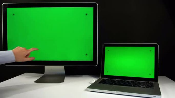 笔记本电脑和带有绿色屏幕的显示器