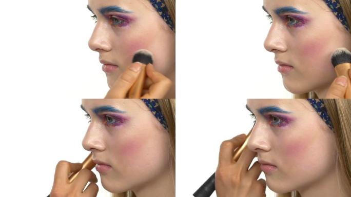 眼部化妆的女人涂抹眼影，制作异国情调，一个，蓝色眉毛，黄色阴影，腮红，睫毛膏，画龙点睛，特写，白色，