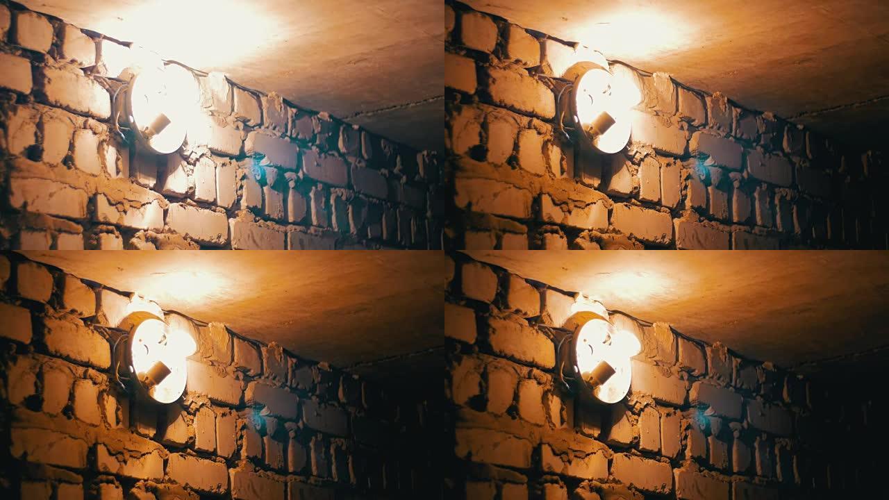 灯丝灯泡在石墙上点亮