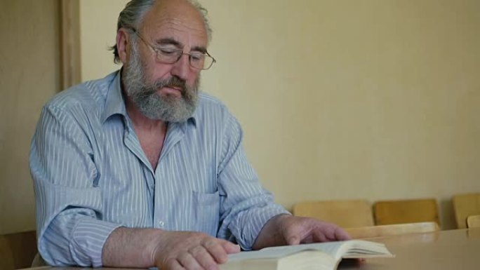 一位资深男子通过眼镜全高清情感阅读书籍