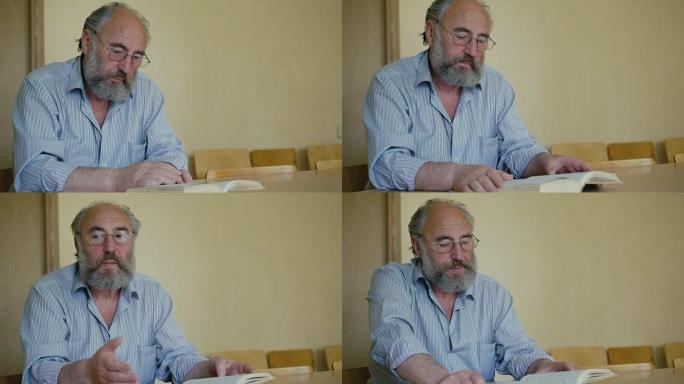 一位资深男子通过眼镜全高清情感阅读书籍