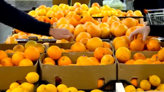 女性和男性的手在商店里拿相同的橙色