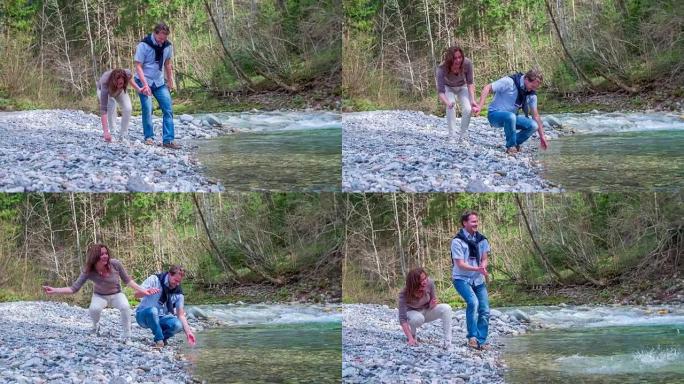这对恋爱中的中年夫妇来到小溪，然后他们就在小溪的水边，他们正流经美丽的风景。