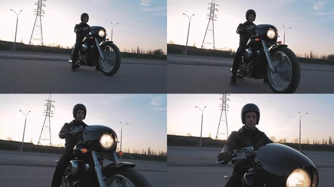 年轻人在日落时分坐在摩托车上慢动作