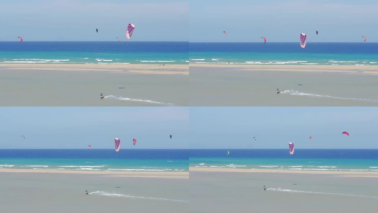 富埃特文图拉-大风天在美丽的海滩上风筝冲浪的人概述