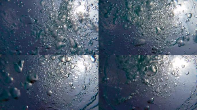 慢动作的气泡向安静的水体表面移动。