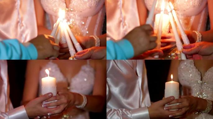 美丽的新婚夫妇点燃蜡烛