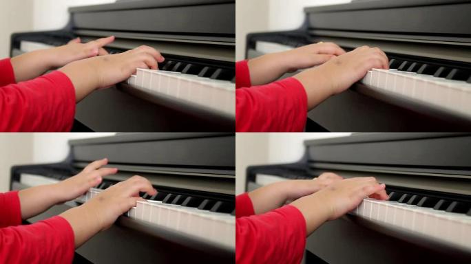 小女孩弹钢琴的手的特写