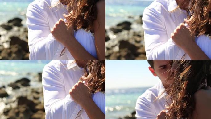 美丽的新婚夫妇在海岸上温柔地牵着手。埃及的蜜月