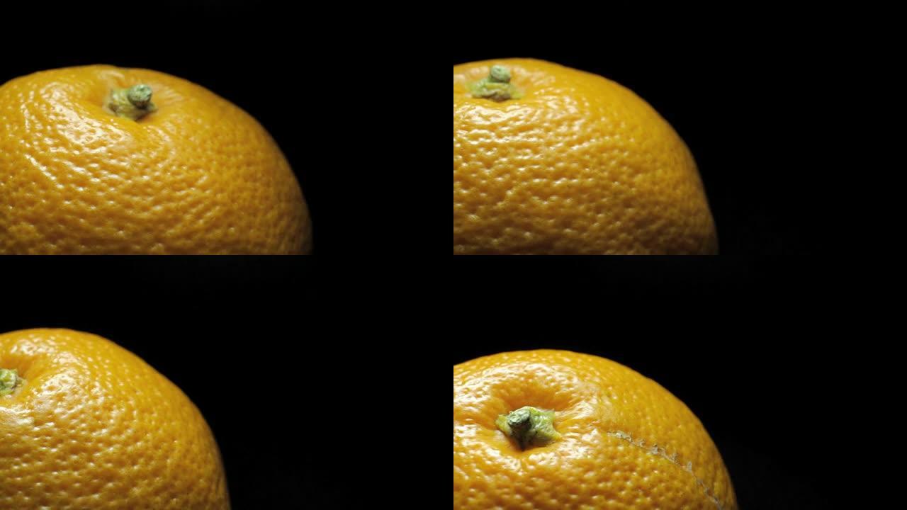 大榨汁橙色，微距在深色背景上旋转